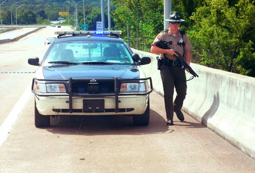 A Tennessee Highway Trooper patrols near the scene of the shooting near the Naval Reserve Center in Chattanooga Tennessee