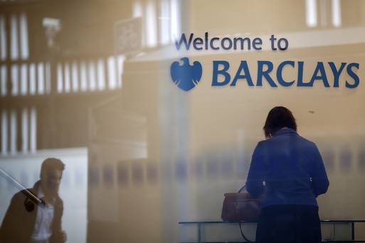 A customer right stands at a desk inside a Barclays Plc bank branch in London U.K