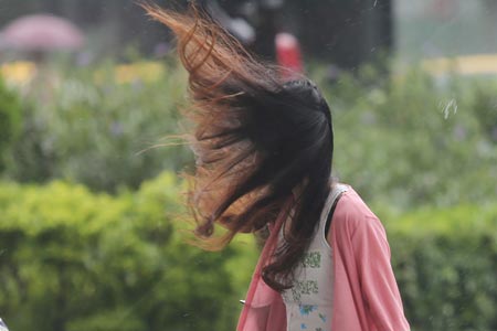 A pedestrian walks on the street in Taipei as Typhoon Chan-hom approaches to northern Taiwan July 10