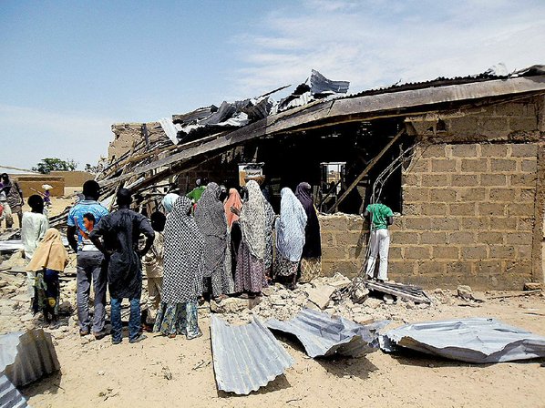 Adamu Adamu						Credit AP				People gather Sunday at the site of a suicide bomb attack at a church in Potiskum Nigeria