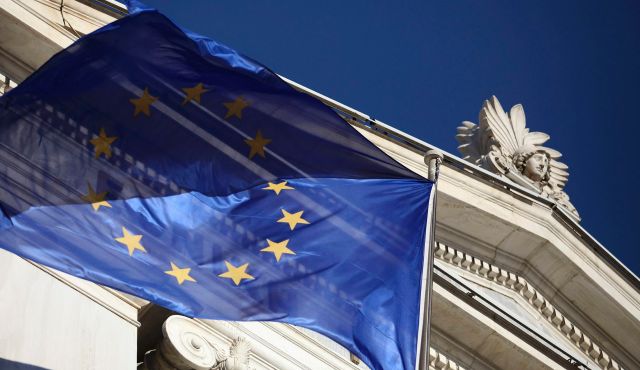 An EU flag flies outside the National Bank of Greece in Athens