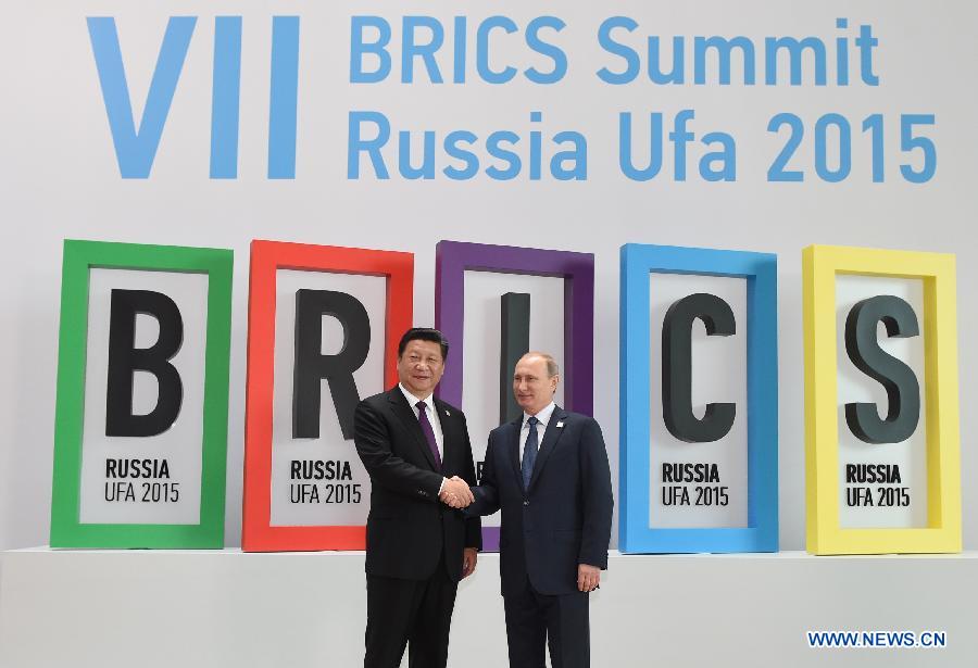 Chinese President Xi Jinping is welcomed by his Russian counterpart Vladimir Putin during the 7th BRICS summit in Ufa Russia