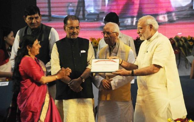 Prime Minister Narendra Modi gives Chaudhary Charan Singh Award for excellence in Journalism in Agricultural Research and Development 2014 to Gargi Parsai Associate Editor The Hindu during 87th ICAR Foundation Day in Patna on Saturday