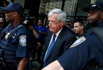 Former U.S. House of Representatives Speaker Dennis Hastert is surrounded by officers as he leaves federal court after pleading not guilty to federal charges of trying to hide large cash transactions and lying to the FBI in Chicago Illinois United State