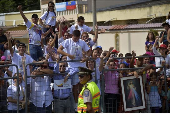 People cheer while waiting for Pope Francis in Guayaquil July 6. Pope Francis in South America on a three-nation tour will perform an open-air mass with more than a million faithful expected to attend