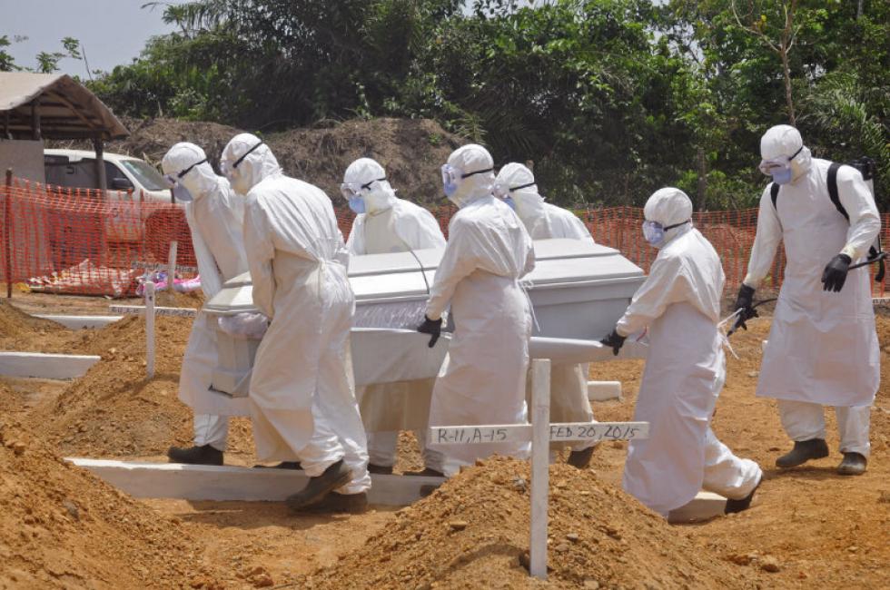 Associated Press
Health workers carry a body of a person that they suspected died from the Ebola virus March 11 at a new graveyard on the outskirts of Monrovia Liberia. A panel commissioned by the World Health Organization to assess its bungled response