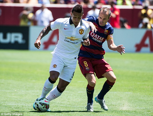 Barcelona's Andres Iniesta attempts a tackle on Manchester United's Memphis Depay on Saturday