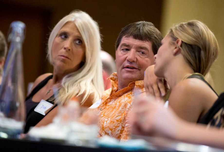 Dean DeMoe center with his wife Deb DeMoe left and their daughter Mc Kenna DeMoe 19 right attend the Alzheimer's Association International Conference in Washington Saturday