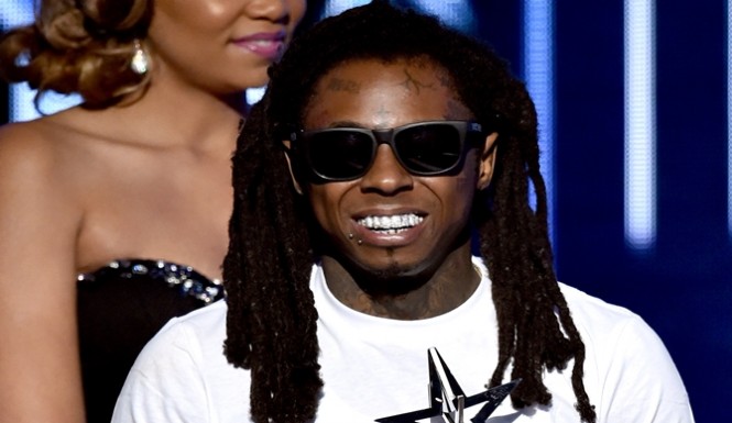 Lil Wayne holds Best Female Hip Hop Artist award during the BET AWARDS '14