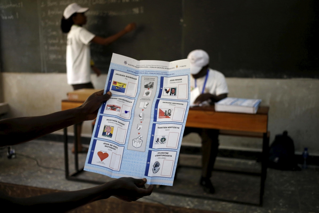 An election official holds up a ballot for scrutiny during vote counting in Burundi's presidential elections in the capital Bujumbura