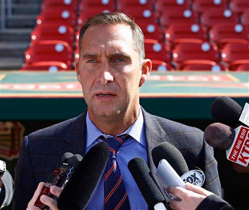 St. Louis Cardinals General Manager John Mozeliak addresses members of the media prior to a baseball game against the Philadelphia Phillies in St. Louis. The St. Louis Cardinals say they have fired scouti