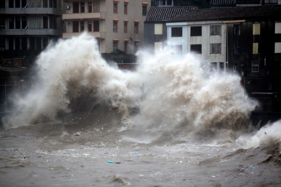 A strong wave breaks along the shore ahead of the landfall of Typhoon Chan Hom in Wenling in eastern China's Zhejiang province Friday