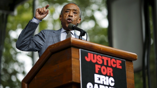 Rev. Al Sharpton speaks to protesters during a rally near a New York court on Saturday. Family and supporters marked the anniversary of the police killing of Eric Garner with rallies and vigils demanding police reforms and justice in the controversial cas