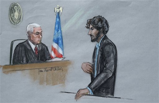 In this courtroom sketch Boston Marathon bomber Dzhokhar Tsarnaev right stands before U.S. District Judge George O'Toole Jr. as he addresses the court during his sentencing Wednesday