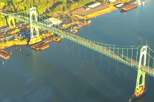 Protestors are dangling from a Portland bridge in a spectacular effort to block Shell's Arctic vessel