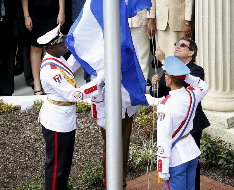 The Cuban flag is raised by Cuban Foreign Minister Bruno Rodriguez as the Embassy reopens during an official ceremony in Washington. – Reuters pic