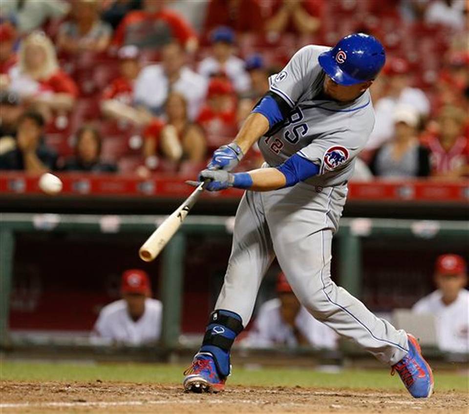 Chicago Cubs&#39 Kyle Schwarber hits a go-ahead home run off Cincinnati Reds relief pitcher Nate Adcock during the 13th inning of a baseball game Tuesday