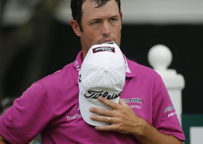 Robert Streb takes a bite out of his hat as he waits to hit on the 18th tee during the final round of the Greenbrier Classic golf tournament at the Greenbrier Resort in White Sulphur Springs