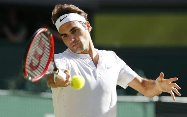 Roger Federer of Switzerland hits a shot during his match against Andy Murray of Britain at the Wimbledon Tennis Championships in London