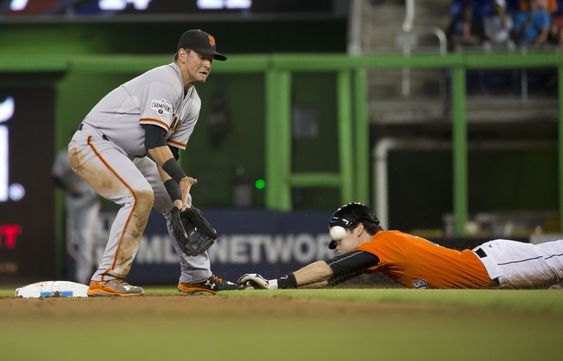 Yelich steals second on a late throw to San Francisco Giants second baseman Joe Panik during the first inning of a baseball game in Miami Thursday