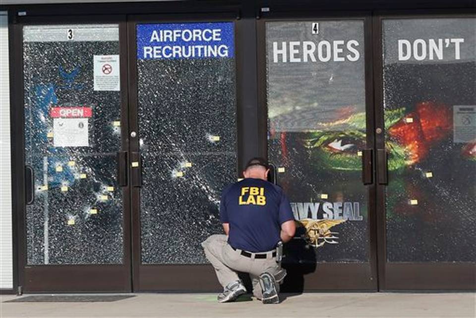 FBI investigator investigates the scene of a shooting outside a military recruiting center in Chattanooga Tenn. The deadly shootings of Marines at two Tennessee military sites illustrate the threat FBI official