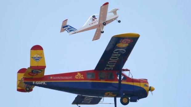 Pilot Hugues Duval in his twin-engined'Cri-Cri, one of the world's smallest electrical planes takes off from an old Broussard aircraft on which it was attached to during a flying display at the 51st Paris Air Show