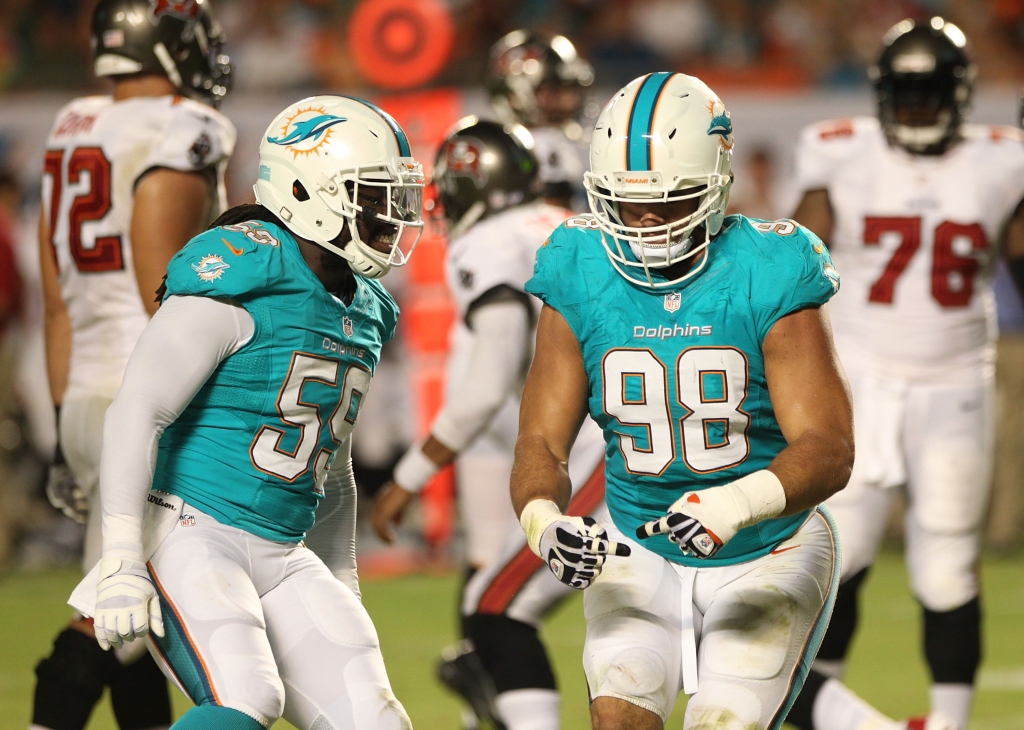 MIAMI GARDENS FL- AUGUST 24 Defensive lineman Jared Odrick #98 of the Miami Dolphins celebrates a sack against Quarterback Josh Freeman #5 of the Tampa Bay Buccaneers at Sun Life Stadium