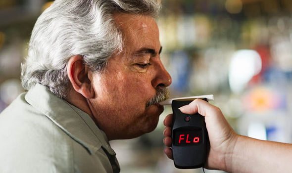 Old man doing breath test for the police