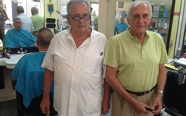 George Kollaros left and his colleague George Panaiotaras in their barbers shop in Plaka near the Acropolis