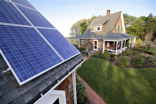 Len Bicknell walks from his house to his garage where his solar energy panels are mounted on the roof in Marshfield Mass. The increasing popularity of home solar panels is prompting environmental groups in Massachus