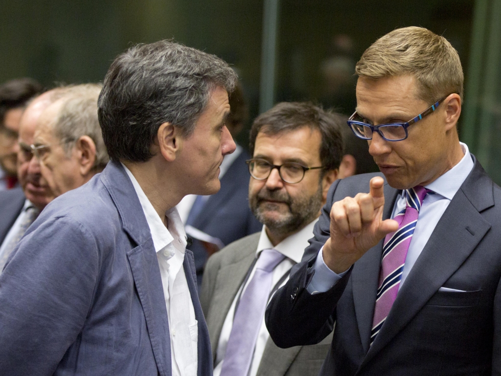 Finnish Finance Minister Alexander Stubb speaks with Greek Finance Minister Euclid Tsakalotos during a round table meeting of eurogroup finance ministers in Brussels on Sunday