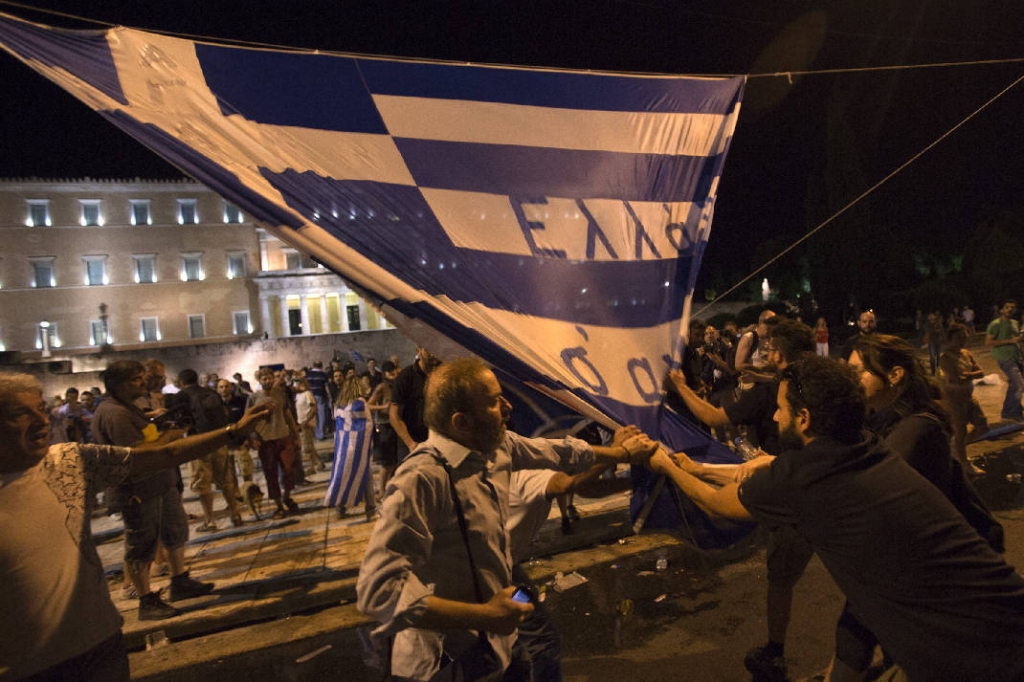 Greek lawmakers have approved the stringent terms of a $94 billion bailout