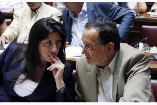 Parliament speaker Zoe Konstantopoulou left speaks with Energy Minister Panagiotis Lafazanis during lawmakers meeting of Syriza governing party at the Greek Parliament in Athens Wednesday. Greece's Prime Minister Alexis Tsipras has faced strident disse