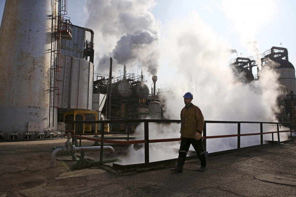 Iranian oil worker walks at Tehran’s oil refinery south of the capital in Iran