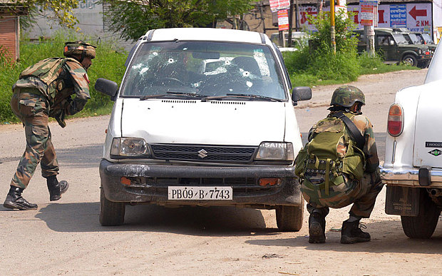 Indian soldiers take cover during the fight in Dinanagar town