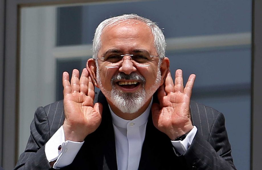 Iranian Foreign Minister Mohammad Javad Zarif gestures to journalists from a balcony outside of the current round of Iran nuclear talks being held in Vienna Austria