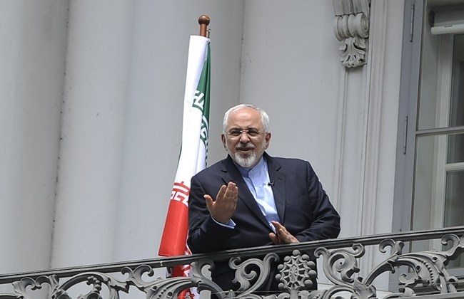 Iranian Foreign Minister Javad Zarif talks to media from bacon of the Palais Coburg Hotel in Vienna Austria