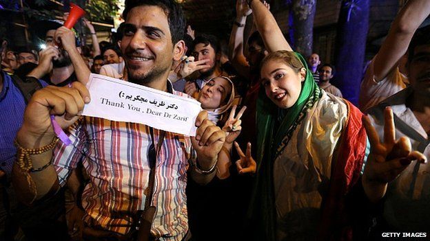 Iranians celebrate after Iran's nuclear negotiating team struck a deal with world powers in Vienna on 14 July 2015