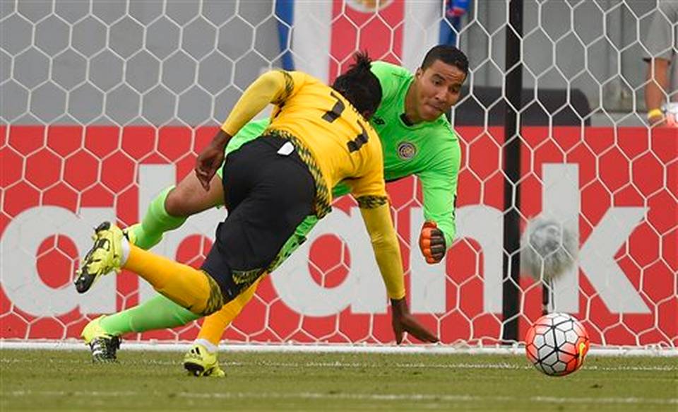 Costa Rica's Esteban Alvarado right makes a stop on a shot as Jamaica's Darren Mattocks runs in during the second half of CONCACAF Gold Cup soccer match Wednesday