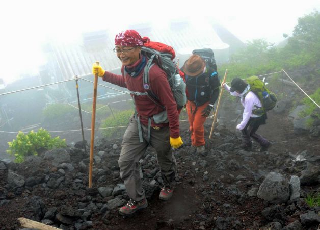 Climbers make their way as a route to climb Mount Fuji on the Shizuoka prefecture side opened for climbing season in Fujinomiya Shizuoka prefecture central Japan Friday