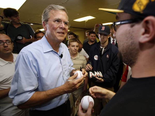 Republican presidential candidate former Florida Gov. Jeb Bush signs autographs following a town hall meeting Wednesday