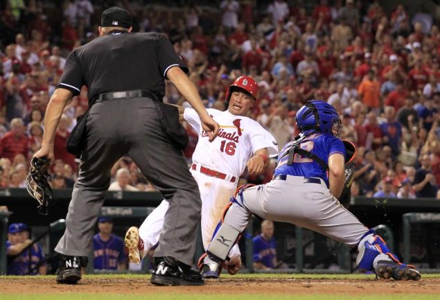 Kolten Wong scores as the ball gets past Mets catcher Kevin Plawecki in the eighth inning