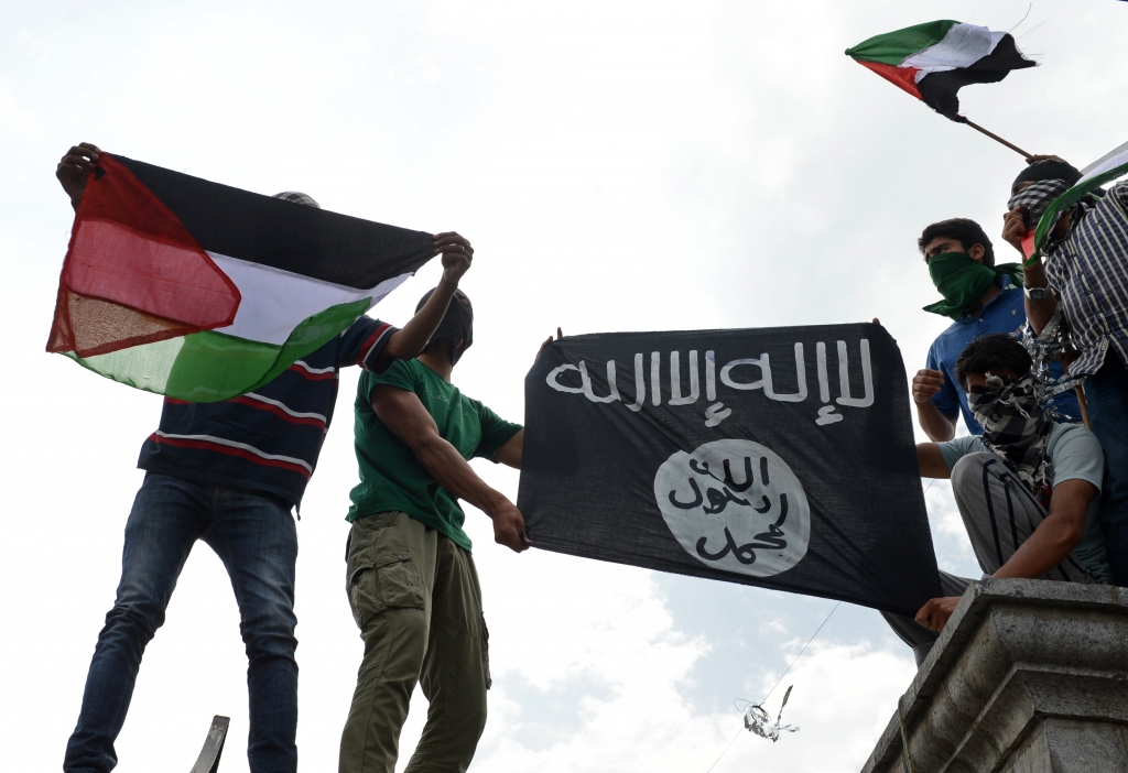 Kashmiri demonstrators hold up Palestinian flags and a flag of the Islamic State of Iraq and the Levant during a demonstration against Israeli military operations in Gaza in downtown Srinagar