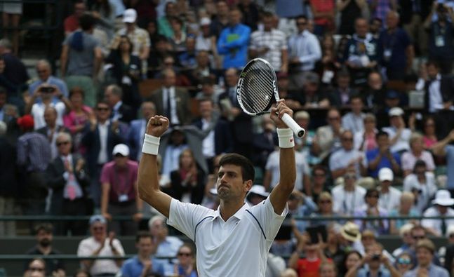 Novak Djokovic of Serbia celebrates winning the singles match against Kevin Anderson of South Africa at the All England Lawn Tennis Championships in Wimbledon London Tuesday