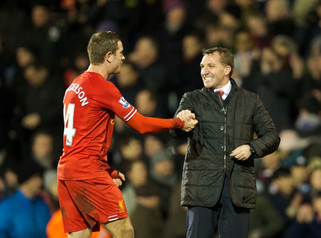 Liverpool's manager Brendan Rodgers celebrates his side's dramatic 3-2 victory over Fulham with Jordan Henderson during the Premiership match at Craven Cottage