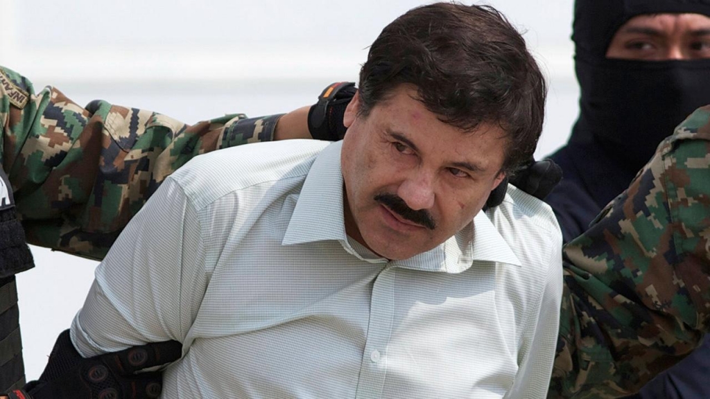 Joaquin El Chapo Guzman head of Mexicos Sinaloa Cartel is escorted to a helicopter in Mexico City following his capture overnight in the beach resort town of Mazatlan