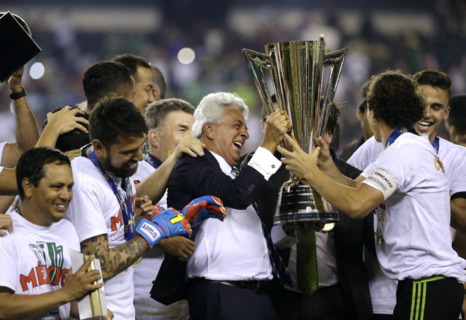 Justino Compean center president of Mexico's football federation celebrates with Mexico players after their 3-1 win over Jamaica in the CONCACAF Gold Cup championship soccer match Sunday