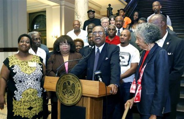 Charles Steele Jr. national president of the Southern Christian Leadership Conference center flanked by local civil rights activists and lawmakers says Confederate symbols represent'treason and need to be removed from public spaces as well as the Mi