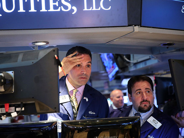 Traders wait for trading to resume at New York Stock Exchange. SPENCER PLATT  GETTY IMAGES