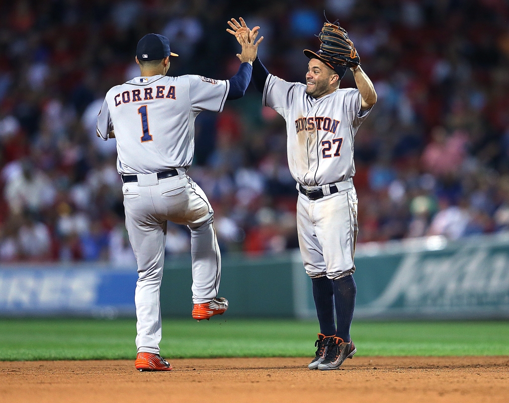 BOSTON MA- JULY 3 Jose Altuve #27 of the Houston Astros and Carlos Correa #1 celebrate a 12-8 win in ten innings against the Boston Red Sox at Fenway Park